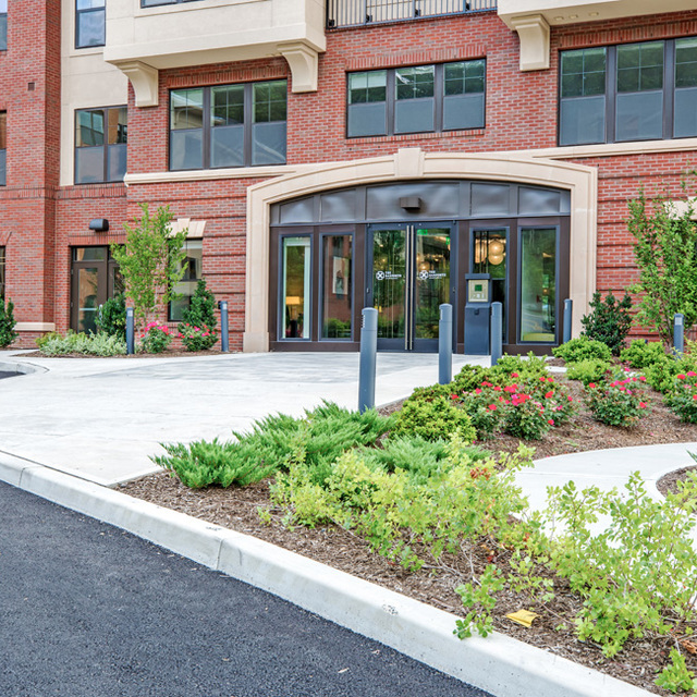 The Danforth - Apartment Entrance with Green Landscape